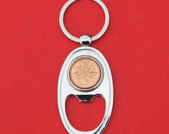 May include: Silver bottle opener keychain with a 1960 Canadian 1 cent coin featuring a maple leaf.