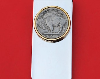 May include: A silver money clip with a gold-rimmed, five-cent buffalo nickel coin inset. The coin features the words "United States of America" and "Five Cents" along with the image of a buffalo.