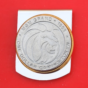 Vintage MGM Grand Casino 1 Dollar Gaming Token Stainless Steel Large Wide Design Money Clip NEW - Las Vegas, NV - Random Year