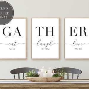May include: Three black and white framed prints with the words "Gather", "Eat Well", "Laugh Often", and "Love Much".