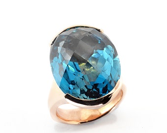 24ct Topaz London Blue 20mmx15mm in 9K pink gold,9gm of solid gold a fabulous ring classic modern design.Price includes shipping insurance.