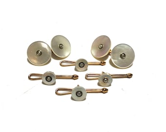 May include: A set of six gold cufflinks and collar stays with mother-of-pearl tops and small pearl accents.