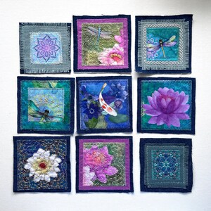 May include: A collection of nine square fabric patches arranged in a grid. The patches feature embroidered and printed designs including dragonflies, koi fish, lotus flowers, and geometric mandala patterns with frayed edges and stitching.