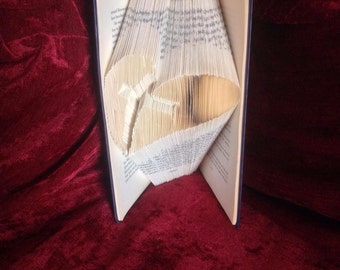 Book folding art pattern for a cross with a heart