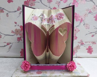 Book folding art pattern for a butterfly with a heart