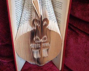 Book folding art pattern for a christmas bauble