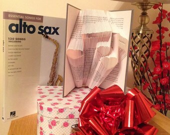 Book folding art pattern for music notes with hearts