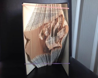 Book folding art pattern for a howling wolf face