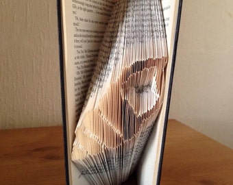 Book folding art pattern for a sea shell