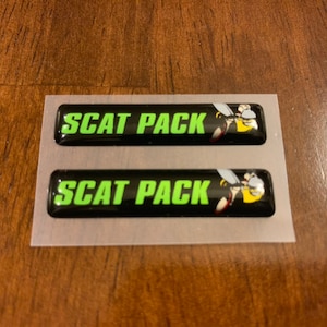 May include: Two black and green "SCAT PACK" decals with a cartoon bee graphic.