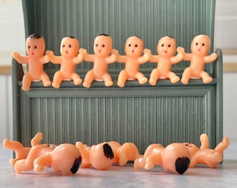 24 tiny plastic babies