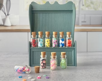 Ten miniature glass jars with toy candy