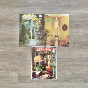 May include: Three instructional craft booklets titled Macrame Elegance II, Macrame Simplicity, and Macrame with Purpose. Each cover features color photography of macrame plant hangers and home decor projects, including hanging lamps and wall art.