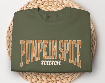 May include: A green sweatshirt with the text "Pumpkin Spice season" in orange letters.