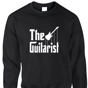 May include: Black sweatshirt with the text "The Guitarist" in a white, stylized font, with a white guitar graphic. The design is reminiscent of a classic movie title. The sweatshirt is a crew neck style.