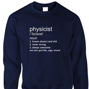 May include: Navy blue sweatshirt with the word "physicist" and its phonetic pronunciation in white text. Below, a humorous definition lists attributes like "knows physics and shit" and "always awesome."