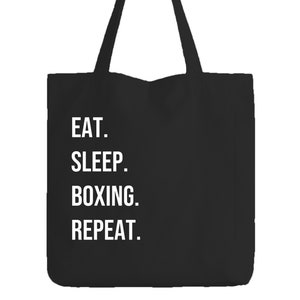 Könnte beinhalten: Schwarze Stofftasche mit weißem Text, der "EAT. SLEEP. BOXING. REPEAT." lautet.