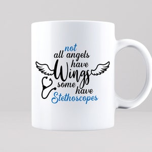 May include: White ceramic coffee mug with a black and blue design. The text on the mug reads "not all angels have wings some have stethoscopes".