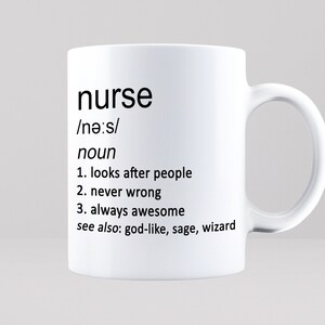 May include: White ceramic mug with a black design that defines the word "nurse" as a noun and lists three characteristics: looks after people, never wrong, and always awesome. The text also includes "see also: god-like, sage, wizard".