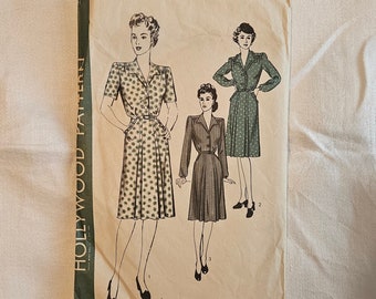 May include: Vintage sewing pattern for a dress, size 16, bust 34, hip 37. The pattern features three illustrations of women wearing the dress in different styles. The pattern is printed on a cream-colored paper with a green border.