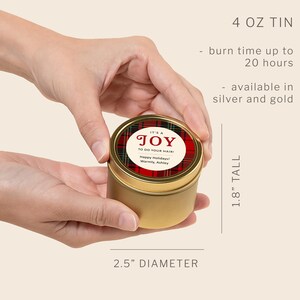 May include: A gold-colored 4 oz metal tin with a 2.5-inch diameter and 1.8-inch height. The lid features a red and green plaid pattern with a circular label reading IT'S A JOY TO DO YOUR HAIR! Happy Holidays! Warmly, Ashley. Burn time up to 20 hours.
