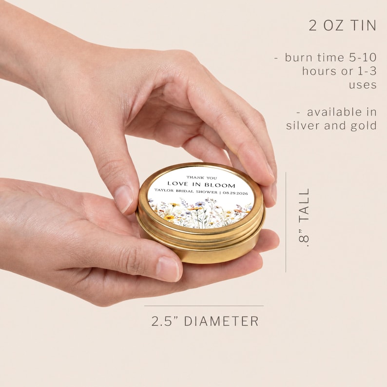 May include: A round gold metal 2 oz tin with a lid featuring a floral design and the text THANK YOU LOVE IN BLOOM TAYLOR BRIDAL SHOWER 08.29.2026. The tin measures 2.5 inches in diameter and 0.8 inches tall, with a burn time of 5-10 hours or 1-3 uses.