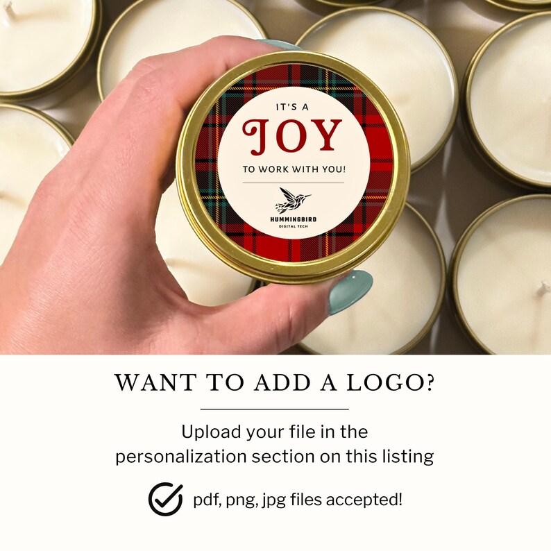 May include: A round gold metal candle tin with a red, green, and black plaid label. The label features a cream-colored center circle with the text IT'S A JOY TO WORK WITH YOU! and a small hummingbird icon above the text HUMMINGBIRD DIGITAL TECH.