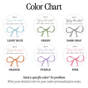 May include: A color chart featuring six circular stickers with the text 'SHE'S Tying the Knot' and 'CASEY'S BRIDAL SHOWER | 05.05.27'. Each sticker displays a watercolor-style ribbon bow in light blue, green, dark gray, orange, purple, or pink.