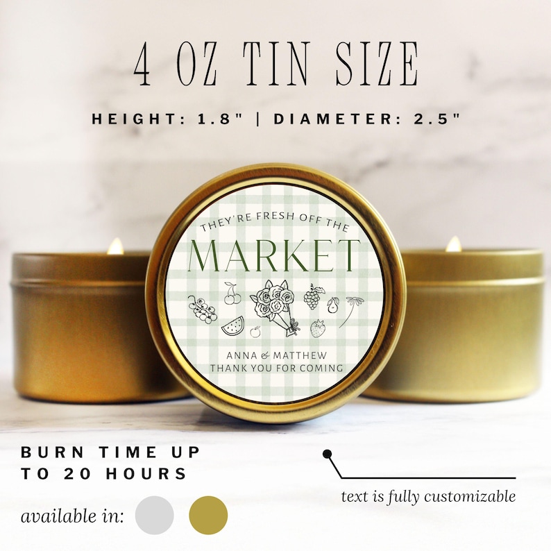 May include: Gold-colored tin candle with a label that reads "THEY'RE FRESH OFF THE MARKET." The candle is 1.8 inches high and 2.5 inches in diameter. The label features a green and white checkered pattern with fruit illustrations. The text "ANNA & MATTHEW THANK YOU FOR COMING" is also on the label.