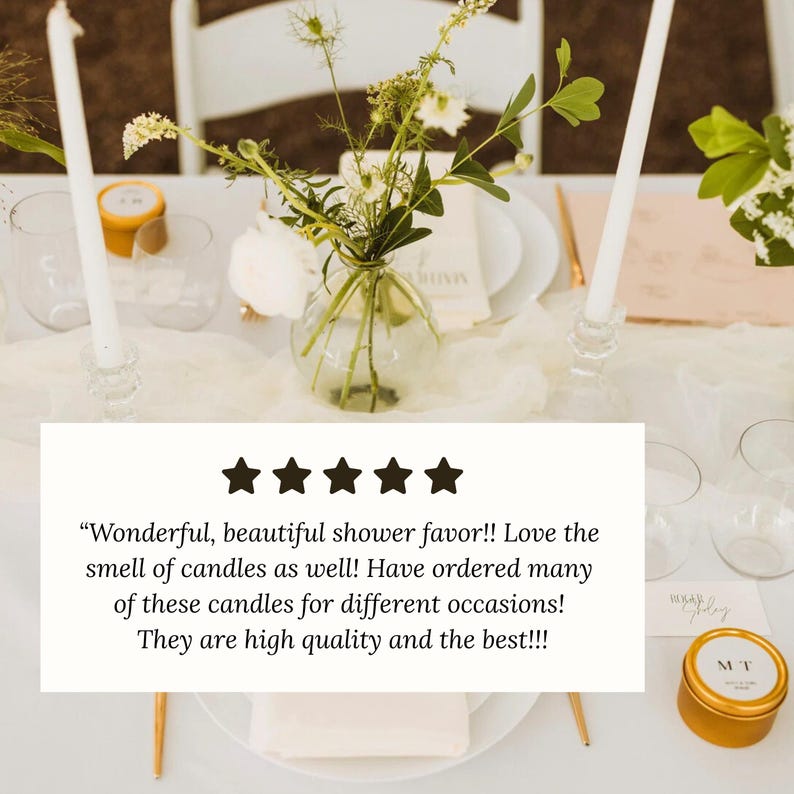 May include: A table setting with white candles, glassware, and a small gold tin with the initials "MT". The table is decorated with flowers in a glass vase and a white tablecloth. The image includes a customer review.