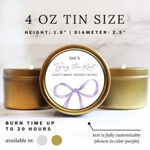 May include: Three gold-colored metal candle tins, each 4 oz in size, measuring 1.8 inches in height and 2.5 inches in diameter. The center label features a purple watercolor bow and the text: SHE'S Tying the Knot CASEY'S BRIDAL SHOWER | 05.05.27.