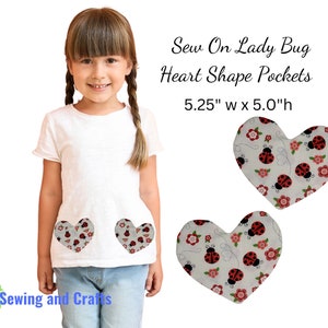 May include: A white t-shirt with two heart-shaped pockets featuring a ladybug and floral print. The pockets are 5.25 inches wide by 5 inches high. Sew On Lady Bug Heart Shape Pockets.