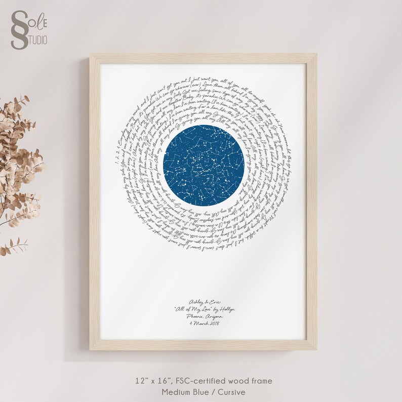 May include: A framed print with a blue star constellation in the center surrounded by a spiral of cursive text. The text reads "Ashley & Eve, All of My Love by Hollyn, Phone Angara, 4 March 2018". The frame is 12 inches by 16 inches and is made of FSC-certified wood.