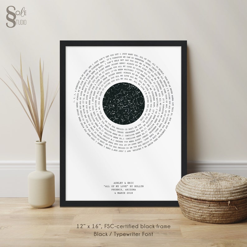 May include: A black and white star map print with a circular design featuring a constellation map in the center. The text around the map includes song lyrics from the song "All of My Love" by Hollen. The print is framed in a black frame and includes the names Ashley & Eric, the date 4 March 2018, and the location Phoenix, Arizona. The print measures 12 inches by 16 inches.