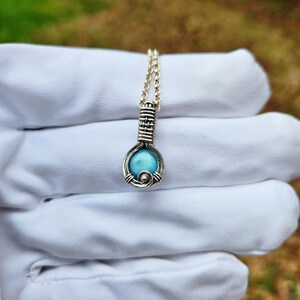 Mini wire wrapped pendant in Larimar with pattern bale