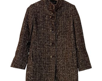 May include: A brown and white tweed coat with a high collar and large brown buttons. The coat has long sleeves and two front pockets. The coat is hanging on a hanger.