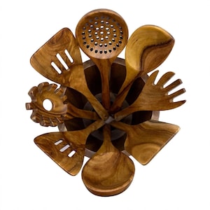 May include: A set of seven brown wooden kitchen utensils arranged in a circular pattern inside a matching cylindrical wooden holder. The collection includes a slotted turner, a pasta fork, a skimmer, a solid spoon, and a wide spatula.