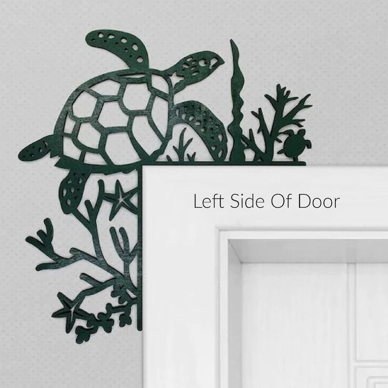 May include: A dark green metal sea turtle and seaweed design door corner decor. The design is attached to the left side of a white door. The text "Left Side Of Door" is printed below the design.
