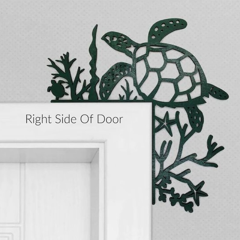 May include: A green metal sea turtle doorstop with a cutout design. The turtle is positioned on a white door frame with the text "Right Side Of Door" below it. The turtle is surrounded by sea life, including seaweed, starfish, and coral.