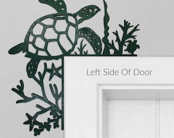 May include: A dark green metal sea turtle and seaweed design door corner decor. The design is attached to the left side of a white door. The text "Left Side Of Door" is printed below the design.
