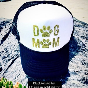 May include: Black and white trucker hat with a gold glitter design that says "DOG MOM".