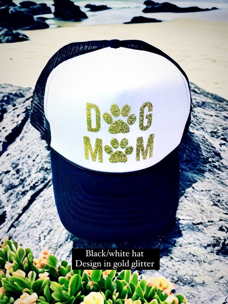 May include: Black and white trucker hat with a gold glitter design that says "DOG MOM".