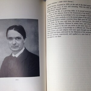 May include: A black and white portrait of a man wearing a suit and tie. The photo is dated 1915.