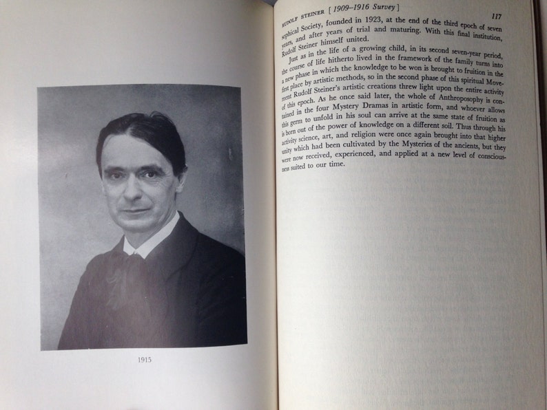 May include: A black and white portrait of a man wearing a suit and tie. The photo is dated 1915.
