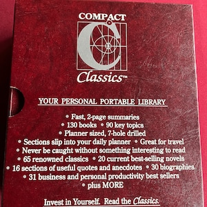 May include: A red box with the title "COMPACT Classics" and the text "YOUR PERSONAL PORTABLE LIBRARY". The box lists features such as "Fast, 2-page summaries", "130 books", "90 key topics", "Planner sized, 7-hole drilled", "Sections slip into your daily planner", "Never be caught without something interesting to read", "65 renowned classics", "20 current best-selling novels", "16 sections of useful quotes and anecdotes", "30 biographies", "31 business and personal productivity best sellers", "plus MORE", and "Invest in Yourself. Read the Classics."