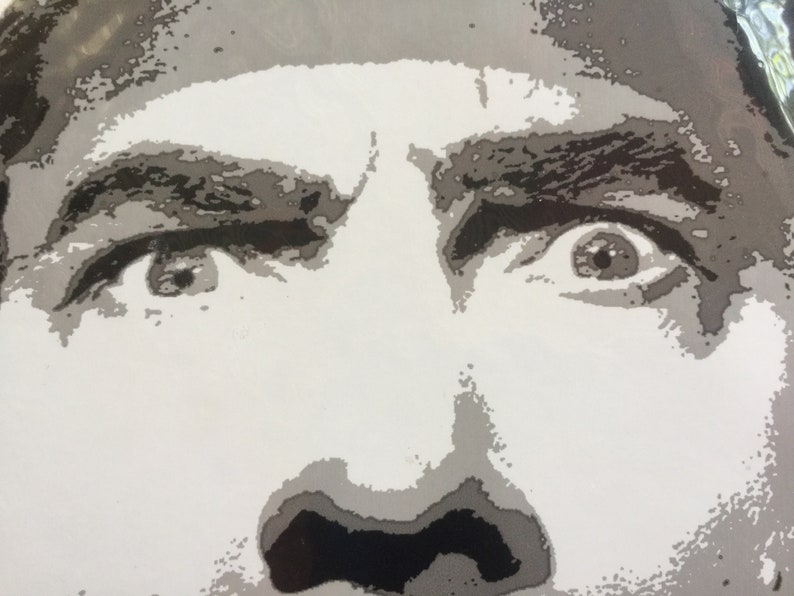 May include: A close-up of a person's face with wide, startled eyes. The person's eyebrows are furrowed and their mouth is slightly open, suggesting surprise or fear.