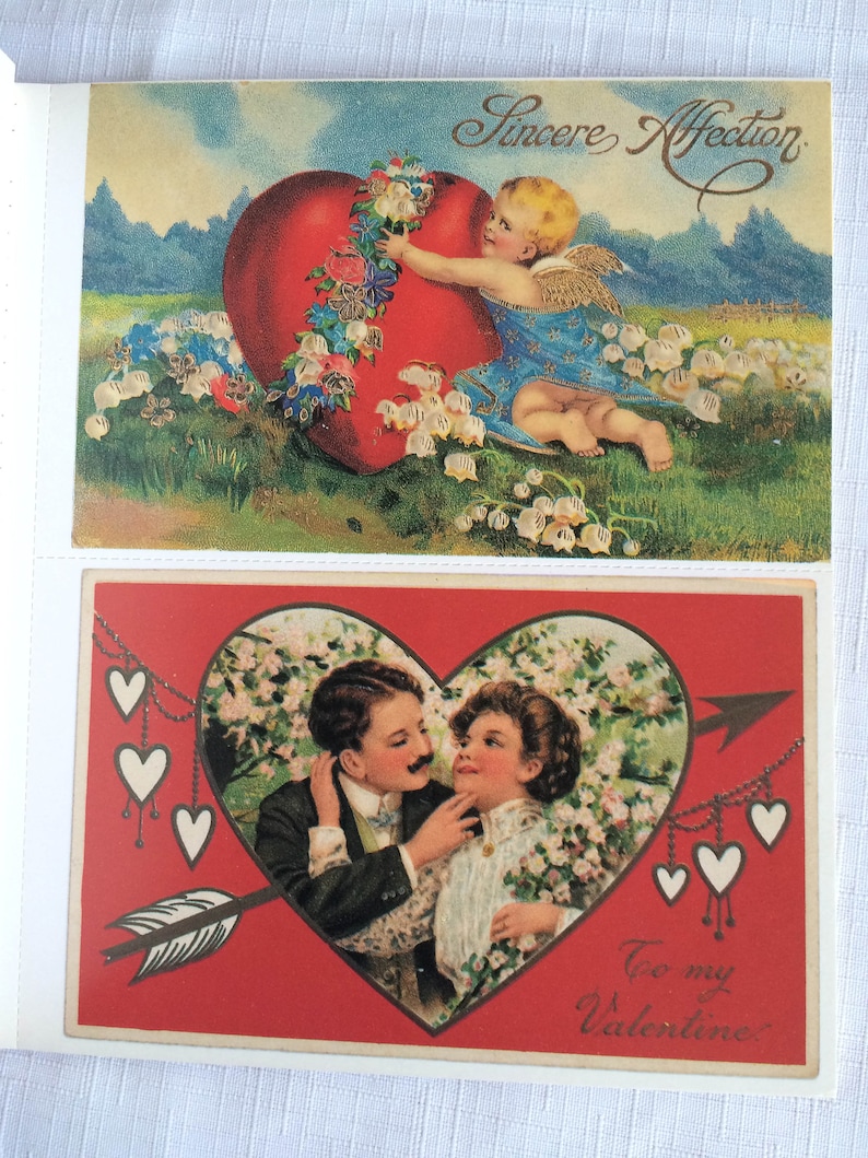 K&ouml;nnte beinhalten: Zwei Vintage-Valentinstagskarten. Die obere Karte zeigt einen Cherub mit Fl&uuml;geln, ein gro&szlig;es rotes Herz und die Worte "Sincere Affection". Die untere Karte zeigt ein Paar in einem Herz mit einem Pfeil und den Worten "To my Valentine."