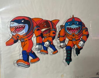 May include: Three cartoon sharks wearing orange and red space suits. The sharks are in a line, with the first shark facing left, the second shark facing right, and the third shark facing left. The sharks have white teeth and black eyes.