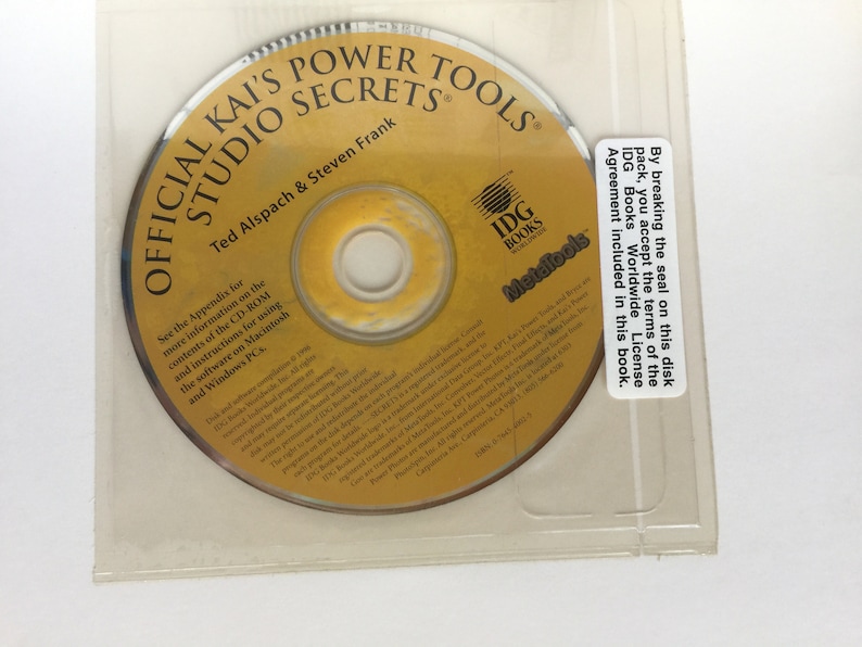 May include: A yellow CD-ROM disc with the title "Official Kai's Power Tools Studio Secrets" and the authors "Ted Alspach & Steven Frank". The disc is labelled with the IDG Books Worldwide logo and the text "Metafools".