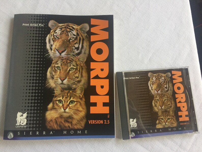 May include: A computer software package for the Print Artist Pro program. The box features a black background with a stack of three animals, a tiger, a cat, and a tabby cat. The title of the software is "MORPH" in orange letters. The text "VERSION 2.5" is in white letters. The software is from Sierra Home.